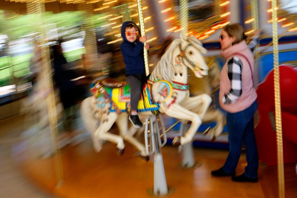 A child rides on Mo's Carousel on Monday, Oct. 17, 2022, at Pumpkinville at the Myriad Botanical Gardens.