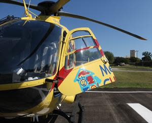 A medical helicopter from Methodist Hospital sits on the newly opened South Texas Blood & Tissue center landing pad. The helipad, the first for a blood bank in Texas, allows medical helicopters to re-stock special blood units and also helps in the transport of blood to locations of major trauma events. The center's  iconic tower and logo are visible in the background.