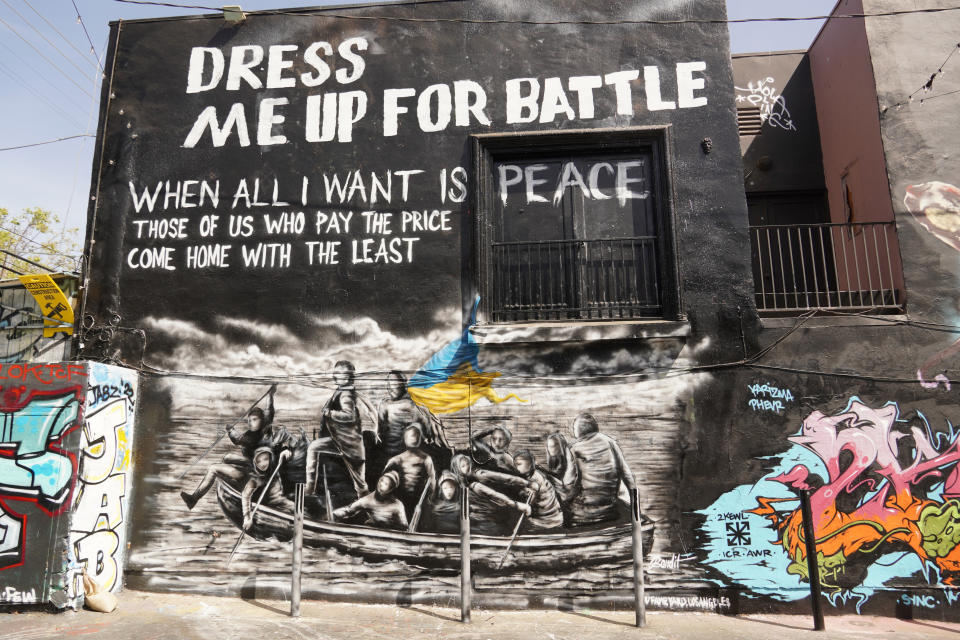 A mural titled "Dress Me Up for Battle" by street artist Bandit is painted on a building wall on Melrose Ave., in Los Angeles, Monday, March 21, 2022. (AP Photo/Eugene Garcia)