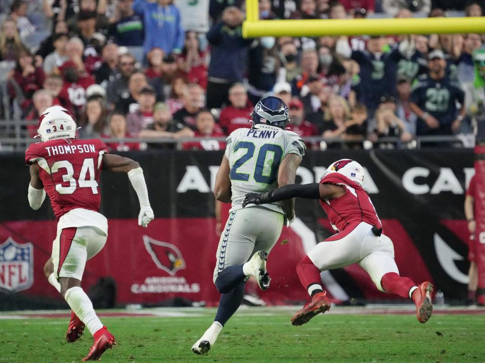 Jan 9, 2022; Glendale, Arizona, USA; Seattle Seahawks running back Rashaad Penny (20) breaks a tackle by Arizona Cardinals safety Budda Baker (3) for a touchdown during the fourth quarter.