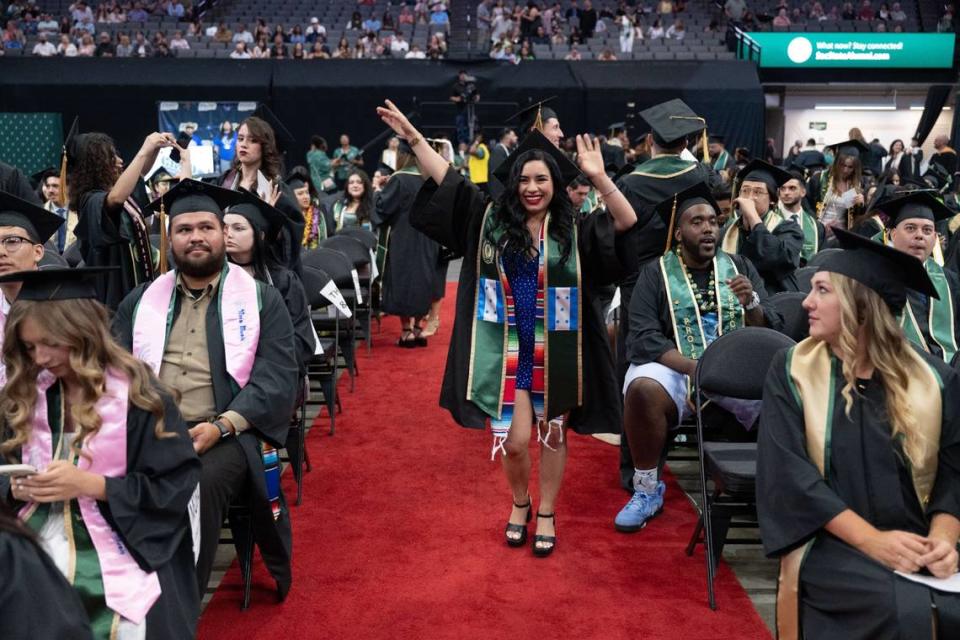Kimberly Gomez Santos, a journalism major, dances in the aisle before the second Sacramento State commencement ceremony at Golden 1 Center on Friday, May 17, 2024.