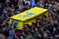 Hezbollah fighters carry the coffin of their comrade, Ali Ibrahim Rmeiti, who was killed by Israeli shelling, during his funeral procession in the southern Beirut suburb of Dahiyeh, Lebanon, Saturday, Nov. 4, 2023. (AP Photo/Bilal Hussein)