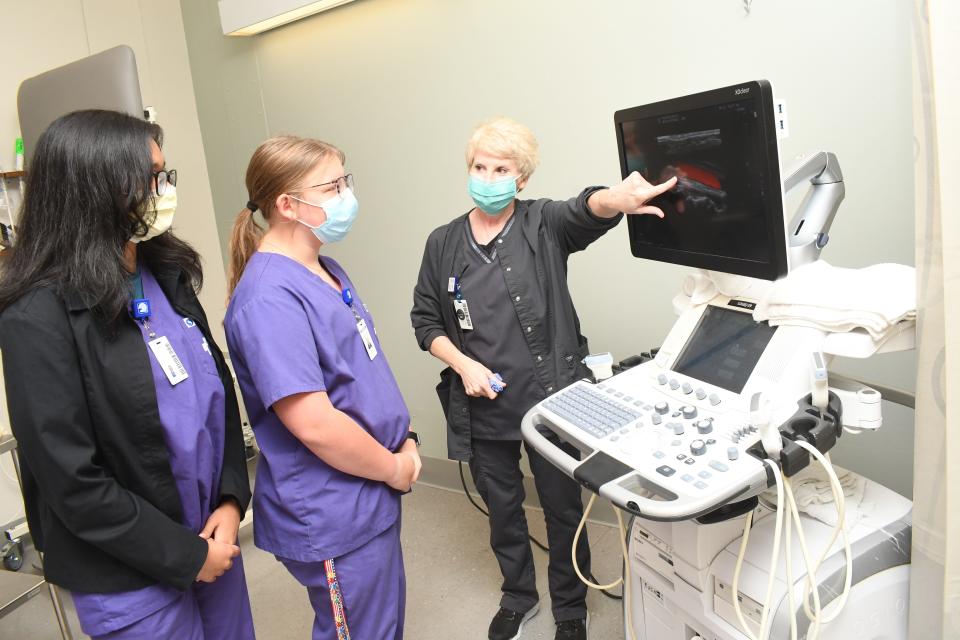 Terri Brouillette (far right), a registered vascular technologist at Rapides Regional Medical Center, shows AHEC students Chloe Cloessner and Anjana Danivas how equipment in the radiology department works.