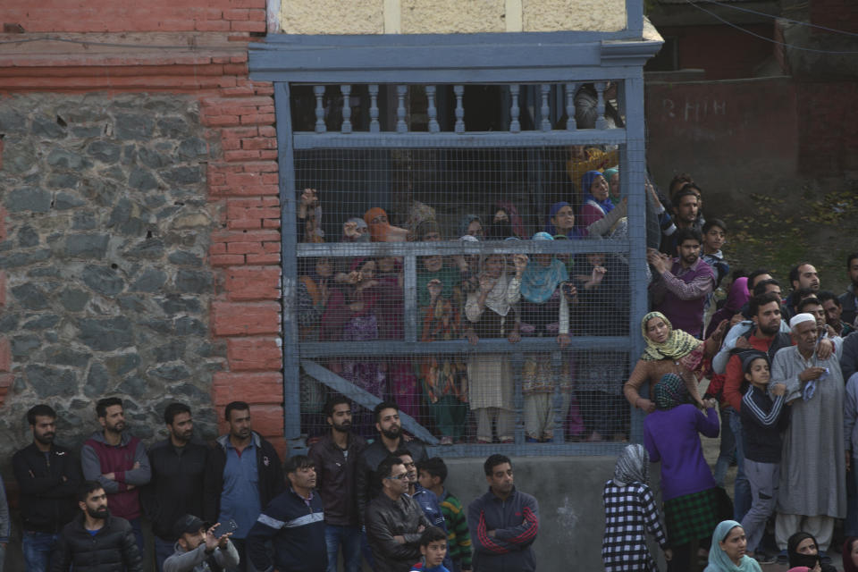 Kashmiri Muslims watch the funeral of Mehraj-Ud-Din Bangroo, a rebel commander in Srinagar, India, Wednesday, Oct. 17, 2018. Anti-India protests and clashes erupted in the main city in disputed Kashmir on Wednesday after a gunbattle between militants and government forces killed at least two suspected rebels, a civilian and a counterinsurgency police official, residents and police said. (AP Photo/Dar Yasin)