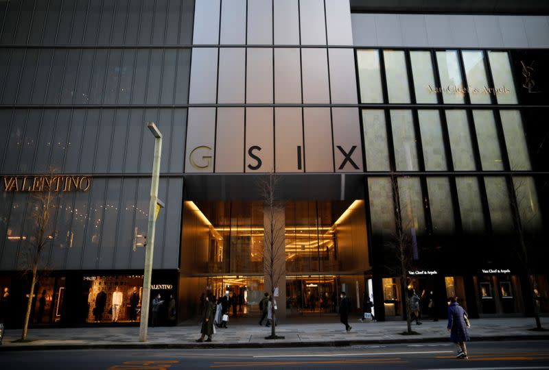 People wearing protective face masks are seen in front of Ginza Six, a luxury shopping complex, amid the coronavirus disease (COVID-19) outbreak, in Tokyo