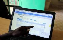 Turkana sub county crops officer Alfons Aurun, displays data coming in from the E-locust phone app on his computer in his office in the town of Lodwar, Turkana county