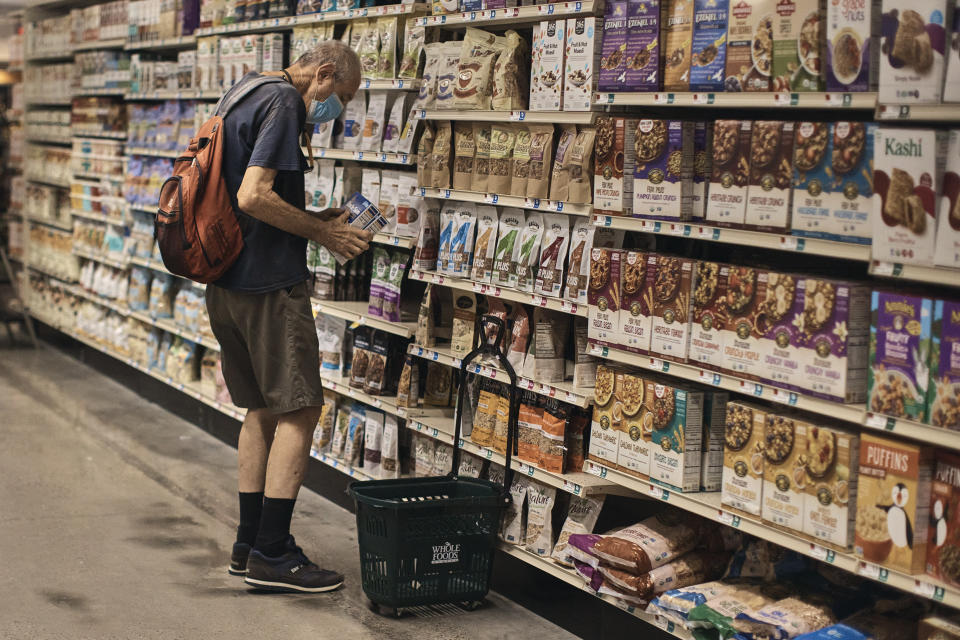 FILE - A man shops at a supermarket on Wednesday, July 27, 2022, in New York. U.S. demand for grocery delivery is cooling as food prices rise. Some shoppers are shifting to less expensive grocery pickup, while others are returning to the store. (AP Photo/Andres Kudacki)