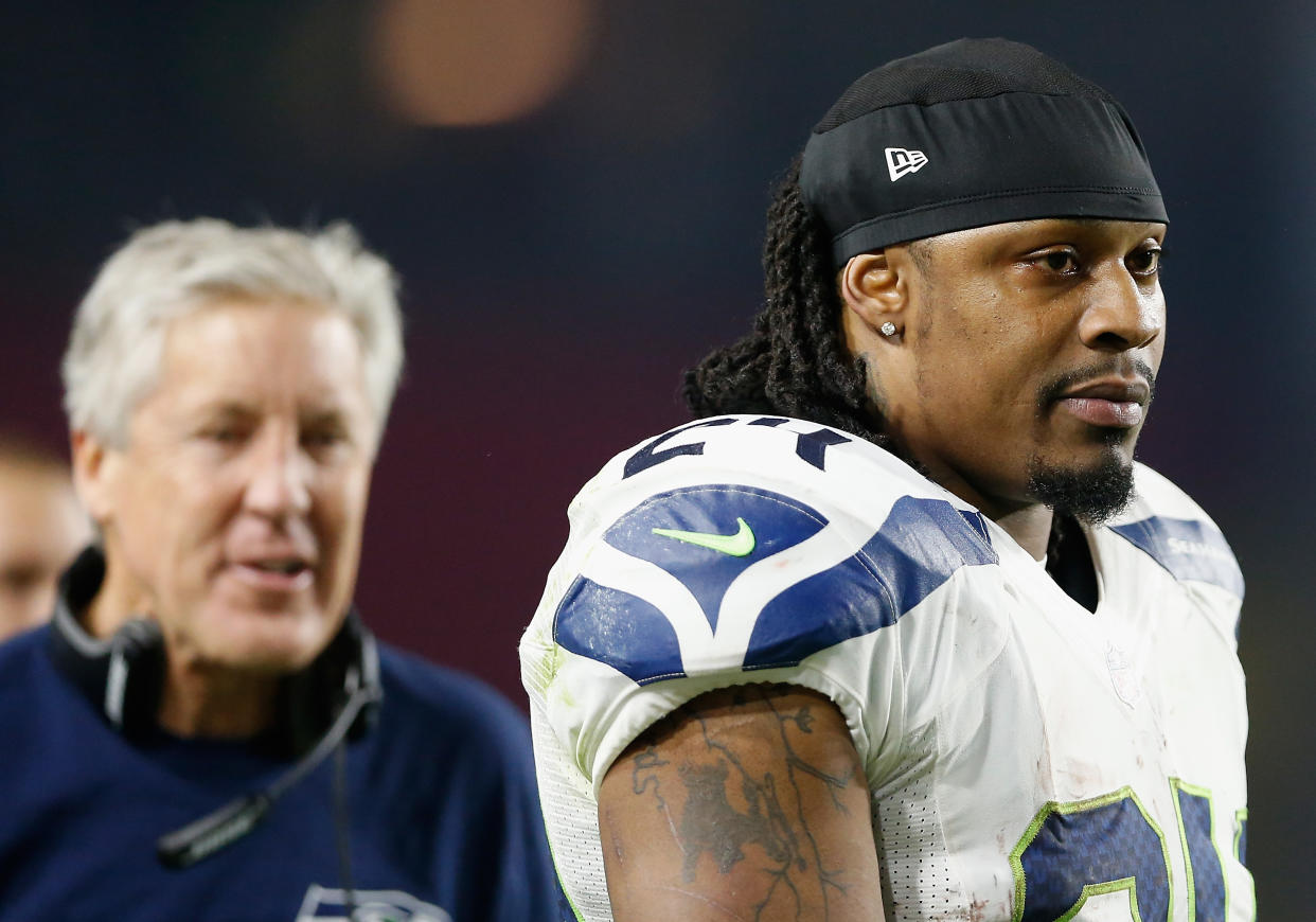 GLENDALE, AZ - DECEMBER 21:  Running back Marshawn Lynch #24 of the Seattle Seahawks walks past head coach Pete Carroll during the NFL game against the Arizona Cardinals at the University of Phoenix Stadium on December 21, 2014 in Glendale, Arizona. The Seahawks defeated the Cardinals 35-6.  (Photo by Christian Petersen/Getty Images)