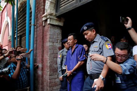 Detained Police Captain Moe Yan Naing is escorted by police as he leaves after a court hearing in Yangon, Myanmar May 9, 2018. REUTERS/Stringer