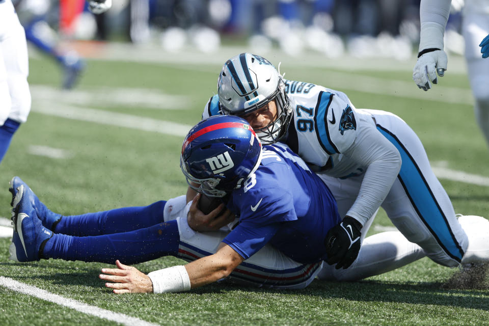 Carolina Panthers' Yetur Gross-Matos, right, tackles New York Giants quarterback Daniel Jones during the first half an NFL football game, Sunday, Sept. 18, 2022, in East Rutherford, N.J. (AP Photo/Noah K. Murray)