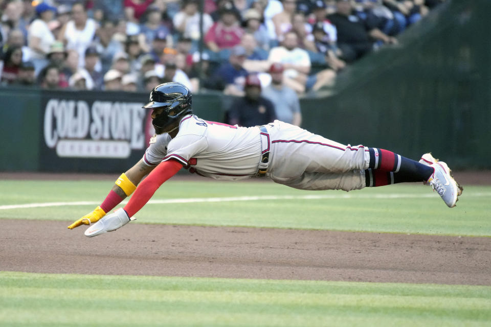 Atlanta Braves Ronald Acuna Jr. dives into third base after going from first to third on a single by Dansby Swanson against the Arizona Diamondbacks in the first inning of a baseball game, Monday, May 30, 2022, in Phoenix. (AP Photo/Rick Scuteri)