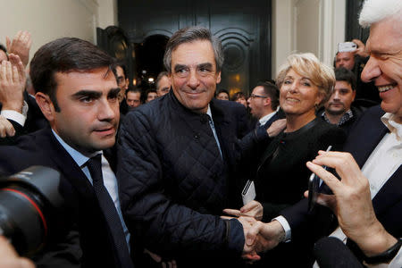 French politician Francois Fillon (C), member of the conservative Les Republicains political party, arrives inside his campaign headquarters after partial results in the first round of the French center-right presidential primary election vote in Paris, France. REUTERS/Thomas Samson/Pool