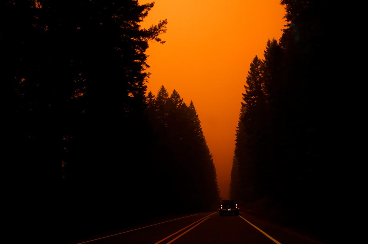 Smoke from the Lionshead Fire and Beachie Creek Fire create an orange glow as an "extremely critical" fire warning is issued on Sept. 7, 2020, on U.S. Highway 22 in Oregon.