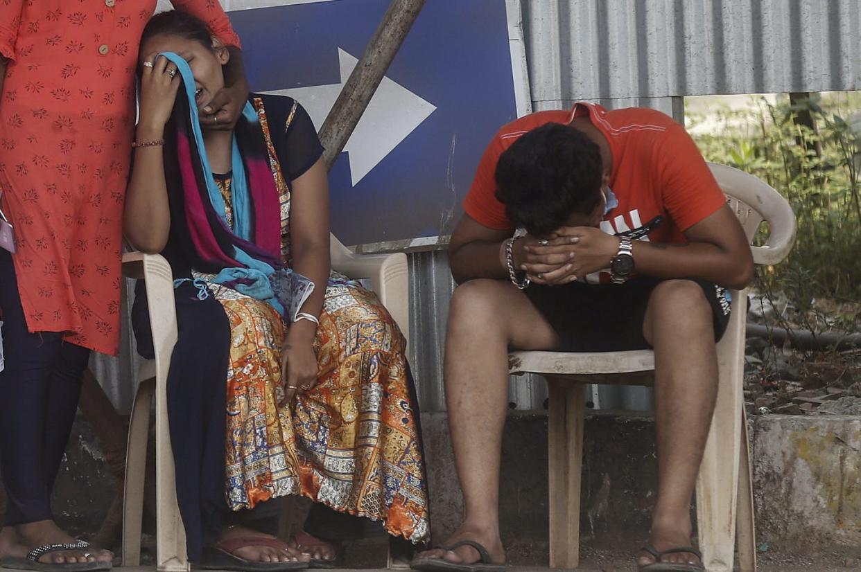 <span class="caption">Relatives of a person who died of COVID-19 mourn outside a field hospital in Mumbai, India, on May 3, 2021.</span> <span class="attribution"><span class="source">(AP Photo/Rafiq Maqbool)</span></span>