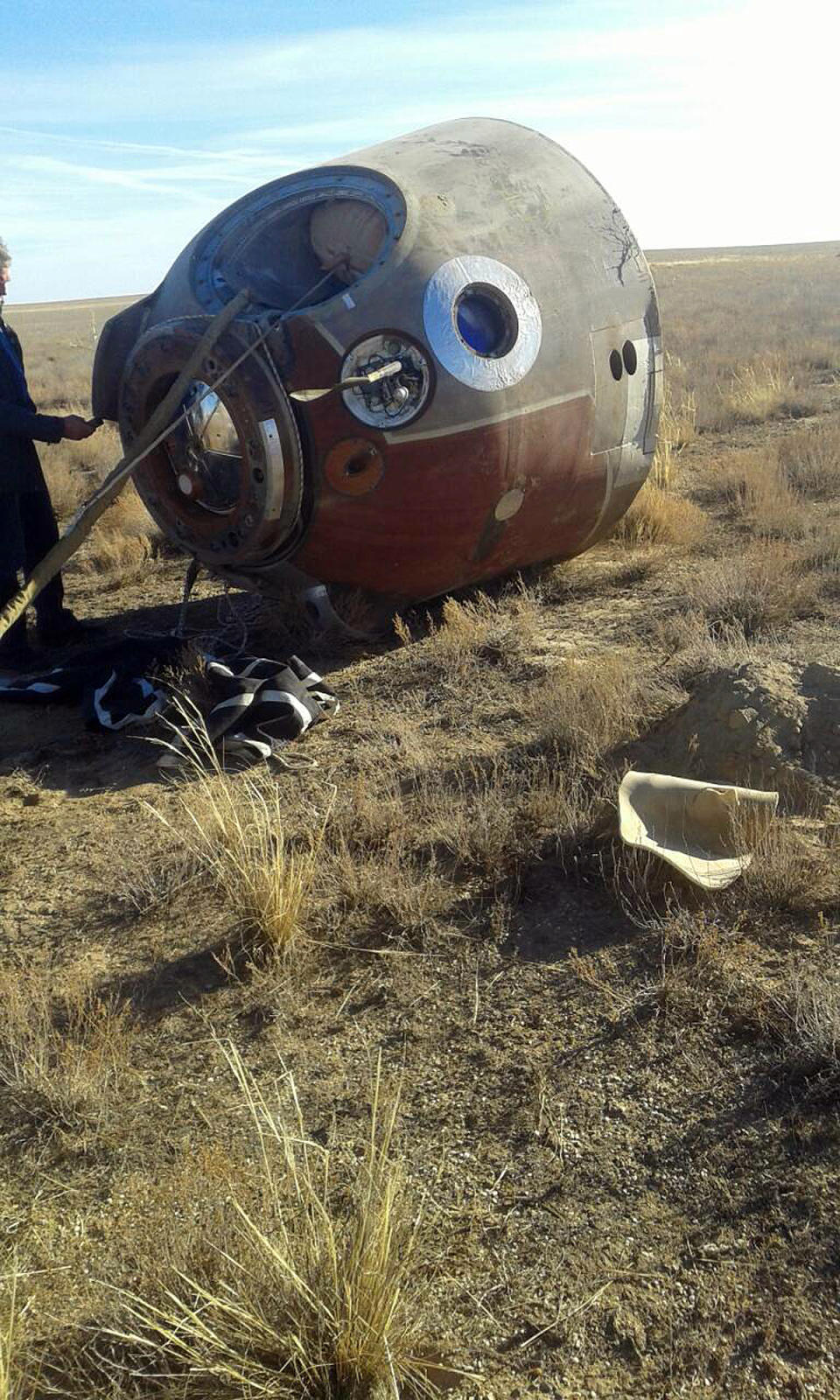 In this photo provided by Russian Defense Ministry Press Service, the Soyuz MS-10 space capsule lays in a field after an emergency landing near Dzhezkazgan, about 450 kilometers (280 miles) northeast of Baikonur, Kazakhstan, Thursday, Oct. 11, 2018. NASA astronaut Nick Hague and Roscosmos' Alexei Ovchinin lifted off as scheduled at 2:40 p.m. (0840 GMT; 4:40 a.m. EDT) Thursday from the Russian-leased Baikonur cosmodrome in Kazakhstan, but their Soyuz booster rocket failed about two minutes after the launch. (Russian Defense Ministry Press Service photo via AP)