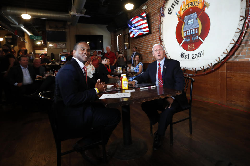 Vice President Mike Pence and Republican U.S. Senate candidate John James sit for lunch at The Engine House in Mount Clemens, Michigan, in June. (Photo: ASSOCIATED PRESS)