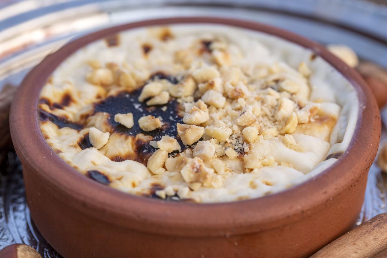 Baked rice pudding turkish milky dessert sutlac in earthenware casserole with hazelnuts