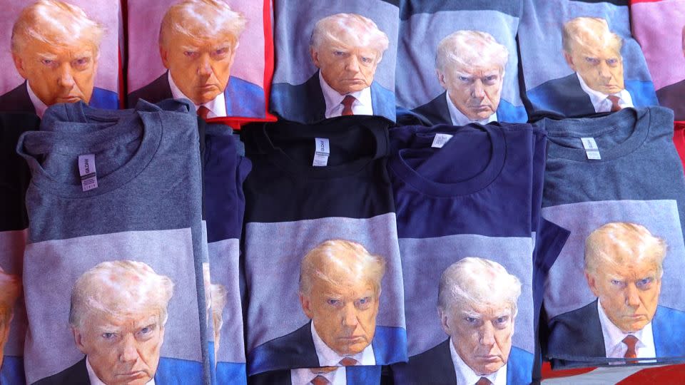 A vendor sells T-shirts featuring Trump's mug shot outside his Rapid City, South Dakota, rally on September 8, 2023. - Scott Olson/Getty Images