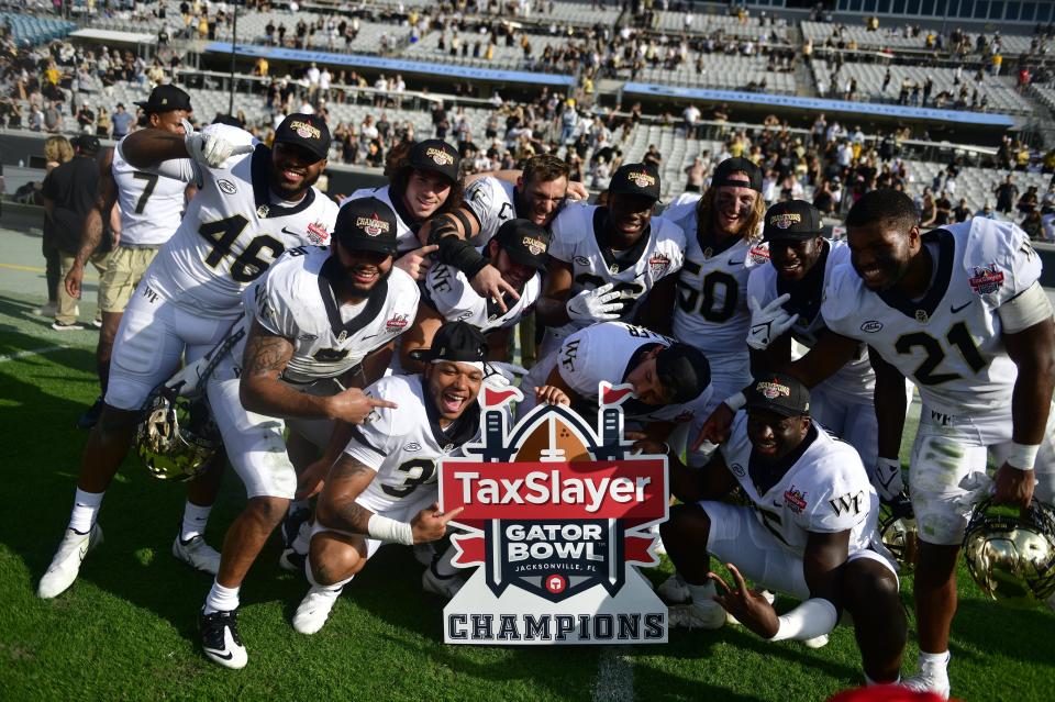 Wake Forest Demon Deacons celebrate after defeating Rutgers 38-10 in the 2021 TaxSlayer Gator Bowl in December.