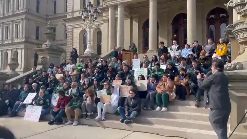 Michigan State University students stage a sit-in on Capitol steps on Feb. 15, 2023, in Lansing, two days after a shooting on campus left three dead.