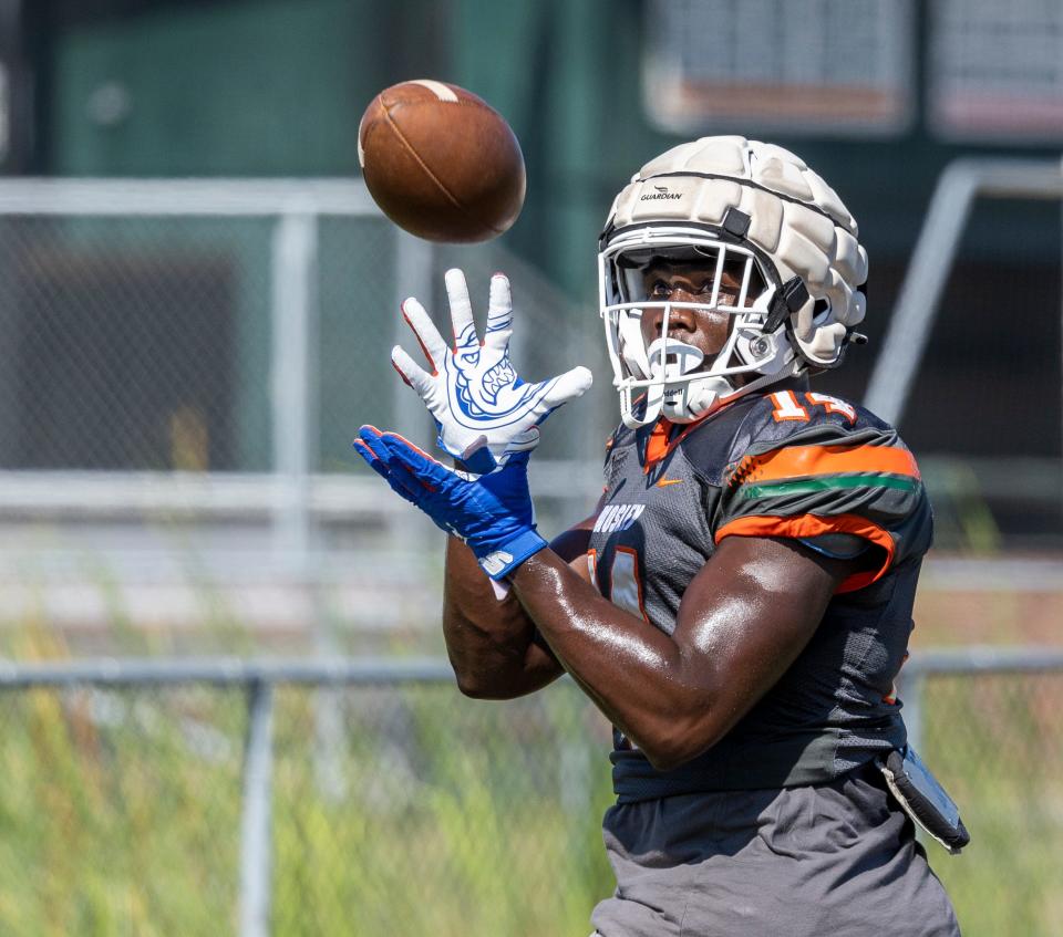 Dolphin Randy Pittman pulls in a pass during practice. Mosley football hit the practice field for spring drills Thursday, May 6, 2022.