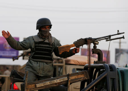 An Afghan policeman keeps watch at a back of truck at the site of an attack in Kabul, Afghanistan December 24, 2018.REUTERS/Omar Sobhani