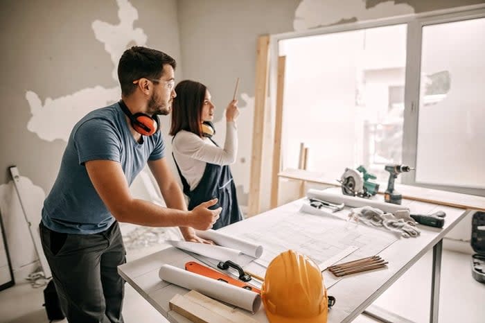 Young couple working together on a home remodel project.