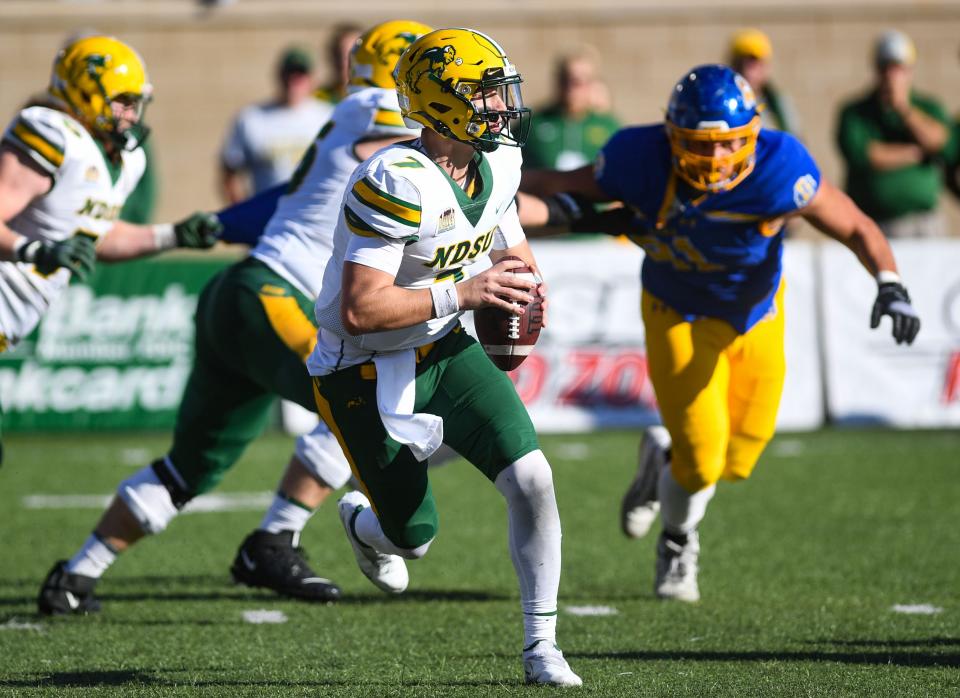 North Dakota State's Cam Miller looks for an opening to make a pass in the annual Dakota Marker game on Saturday, November 6, 2021 at Dana J. Dykhouse Stadium in Brookings.