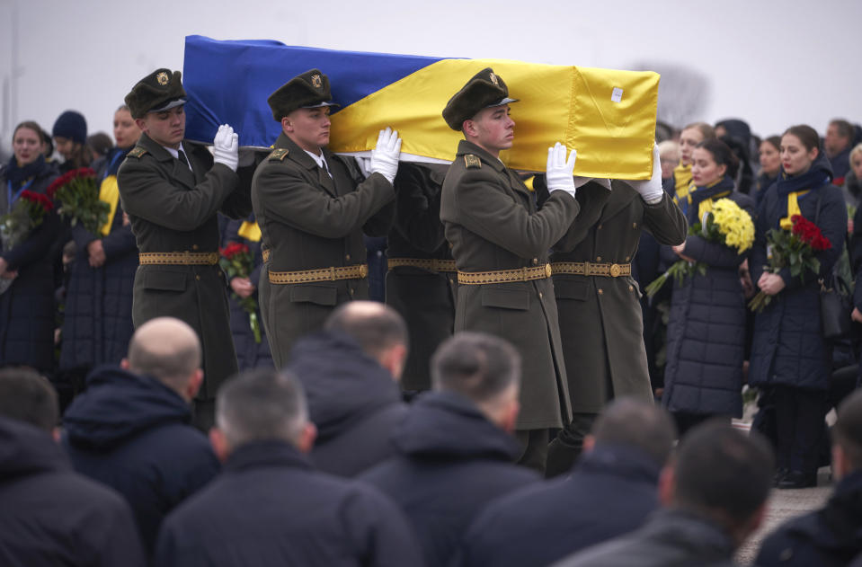 In this photo provided by the Ukrainian Presidential Press Office, honor guard carry a coffin of the one of the eleven Ukrainian victims of the Ukrainian 737-800 plane that crashed on the outskirts of Tehran, at Borispil international airport outside Kyiv, Ukraine, Sunday, Jan. 19, 2020. An Ukrainian passenger jet carrying 176 people has crashed just minutes after taking off from the Iranian capital's main airport on Jan. 8, 2020. (Ukrainian Presidential Press Office via AP)