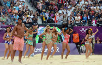 Beach volleyball cheerleaders dance in formation. (David Hecker)