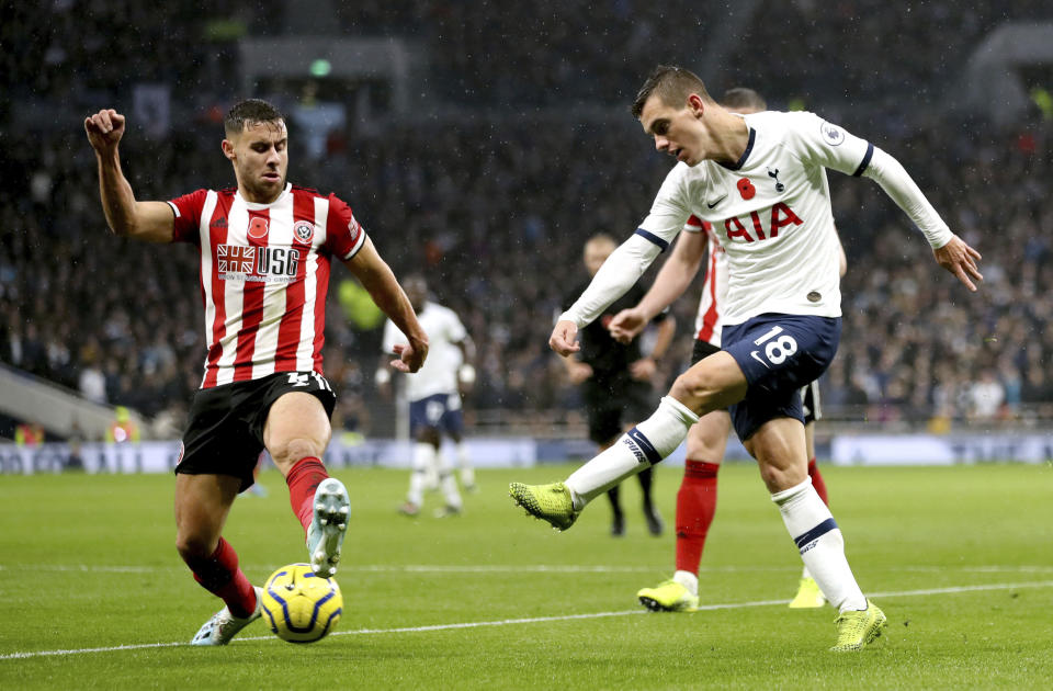 Sheffield United's George Baldock, left and Tottenham Hotspur's Giovani Lo Celso battle for the ball, during the English Premier League soccer match between Tottenham Hotspur and Sheffield United, at Tottenham Hotspur Stadium, in London, Saturday, Nov. 9, 2019. (Bradley Collyer/PA via AP)