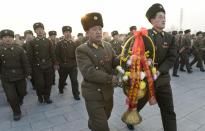 North Korean soldiers offer flowers to bronze statues (not pictured) of North Korea's late founder Kim Il Sung and late leader Kim Jong Il at Mansudae in Pyongyang, in this picture taken and provided by Kyodo December 17, 2013, to mark the second death anniversary of Kim Jong Il. Mandatory credit (REUTERS/Kyodo)