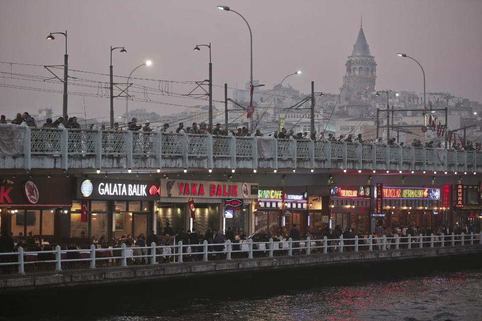 The Galata Tower, a stone medieval observation tower, rear, and Galata Bridge spanning city's Golden Horn waterway, are seen in Istanbul, Turkey, Tuesday, Oct. 29, 2013. Last summer, Istanbul’s Taksim Square was the scene of violent confrontations between police and protesters. But protests have faded, and contrary to some lingering perceptions, it’s quite calm now _ except for the normal hustle and bustle found in this vibrant city. And it’s as safe for tourists as it ever was. Istanbul is a thoroughly modern place, but it traces its roots back to 660 B.C. It’s the former seat of the opulent Byzantine and Ottoman empires and is divided into European and Asian sides by the Bosporus Strait, offering a wealth of history and stunning scenery.(AP Photo)