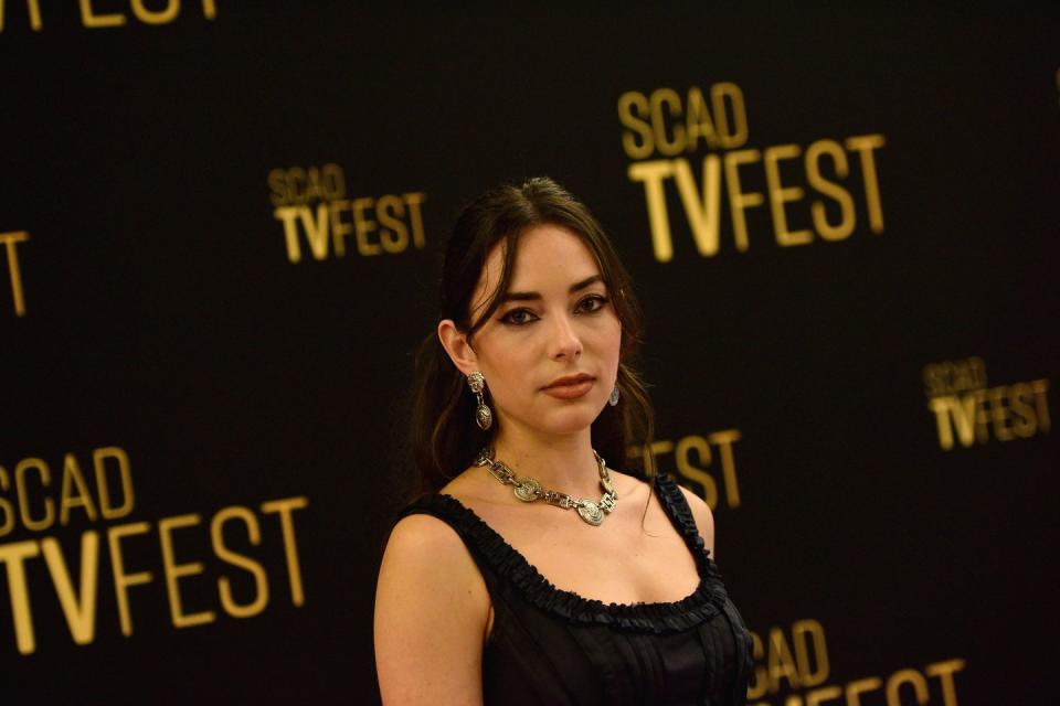 mariel morino in a black dress with a necklace, at a red carpet event