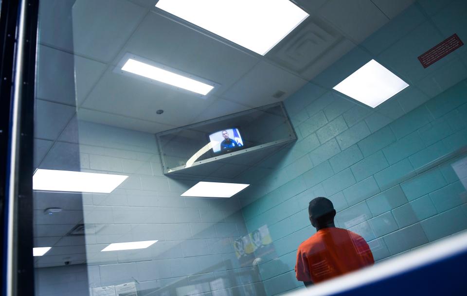 An informational video plays as Incoming and outgoing immigration detainees are processed at the Krome Service Processing Center in Miami, Florida.