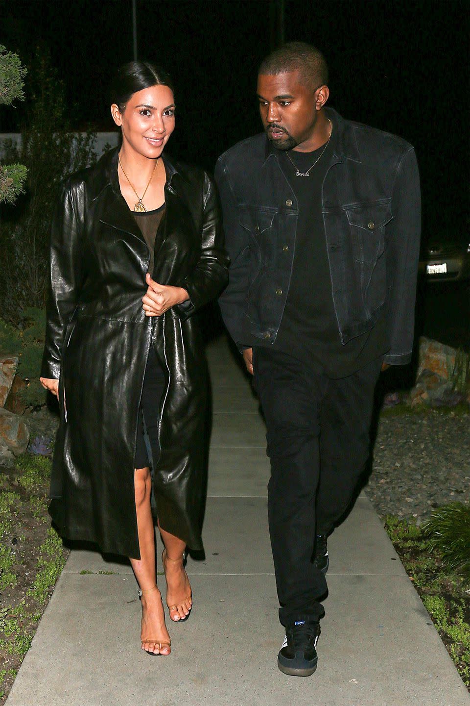 <p>In a sheer mesh bodysuit under a leather trench coat with black frayed bermuda shorts, lucite heels, and a Yeezy x Jacob & Co. pendant necklace while leaving a sushi restaurant with her husband, Kanye West, in Brentwood, CA. </p>