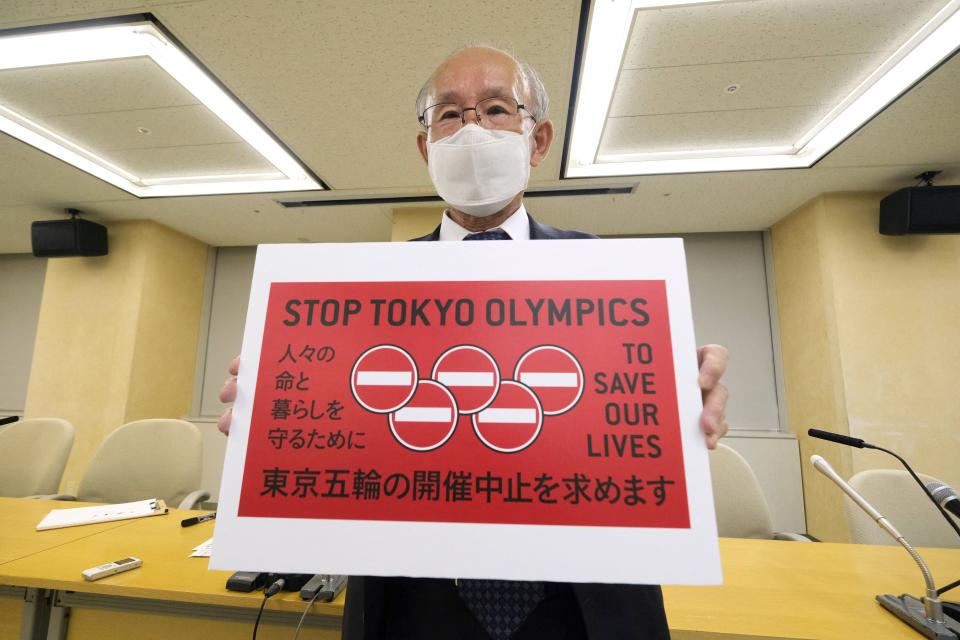 Kenji Utsunomiya, a Japanese lawyer and former Tokyo gubernatorial candidate, poses with a campaign slogan Stop Tokyo Olympics.