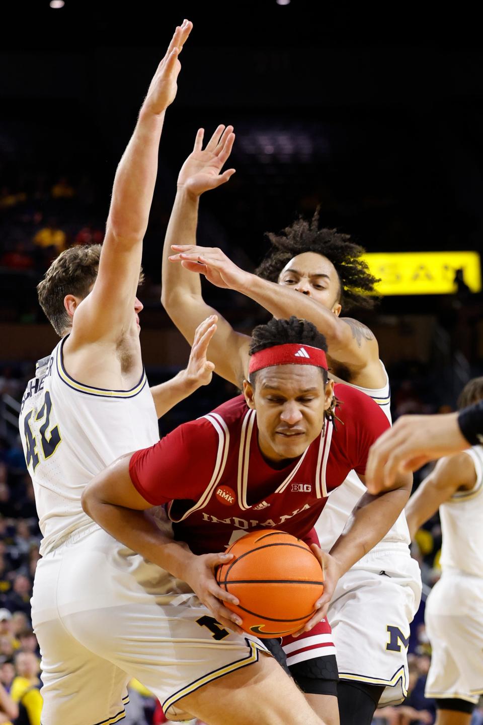 Dec 5, 2023; Ann Arbor, Michigan, USA; Indiana Hoosiers forward Malik Reneau (5) is defended by Michigan Wolverines forward Will Tschetter (42) and forward Terrance Williams II (5) in the second half at Crisler Center.