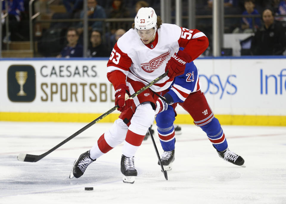 Detroit Red Wings defenseman Moritz Seider (53) skates with the puck in front of New York Rangers center Barclay Goodrow during the second period of an NHL hockey game Sunday, Nov. 6, 2022, in New York. (AP Photo/John Munson)