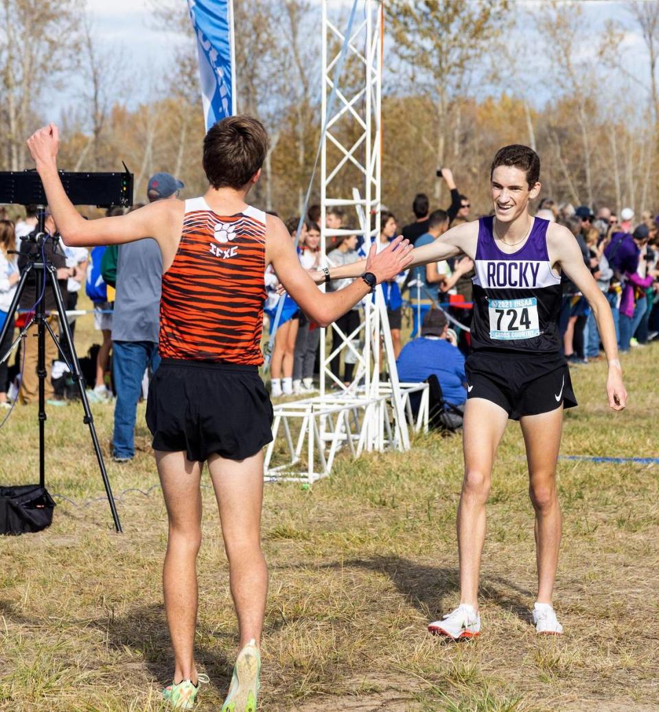First-place finisher Luke Athay of Idaho Falls, left, congratulates second-place finisher Trent Wigod of Rocky Mountain at the 5A boys state cross country race Friday at Eagle Island State Park.
