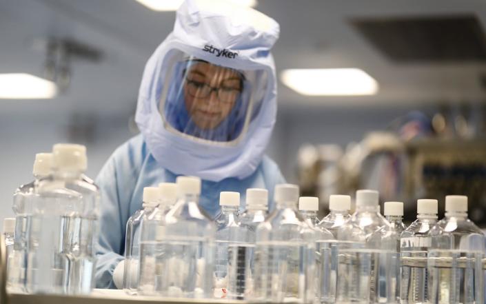 Employees in special suits test the procedures for the manufacturing of the Covid-19 vaccine at German company BioNTech, in Marburg, Germany on March 29, 2021 - Anadolu Agency
