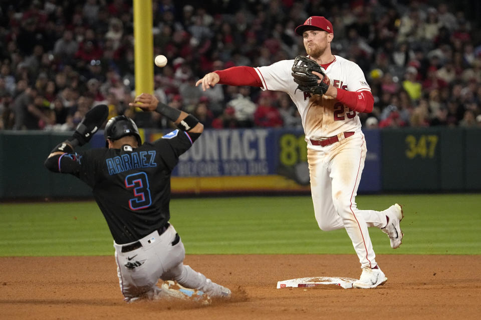 Miami Marlins' Luis Arraez, left, is forced out at second as Los Angeles Angels second baseman Brandon Drury throws out Bryan De La Cruz during the seventh inning of a baseball game Saturday, May 27, 2023, in Anaheim, Calif. (AP Photo/Mark J. Terrill)