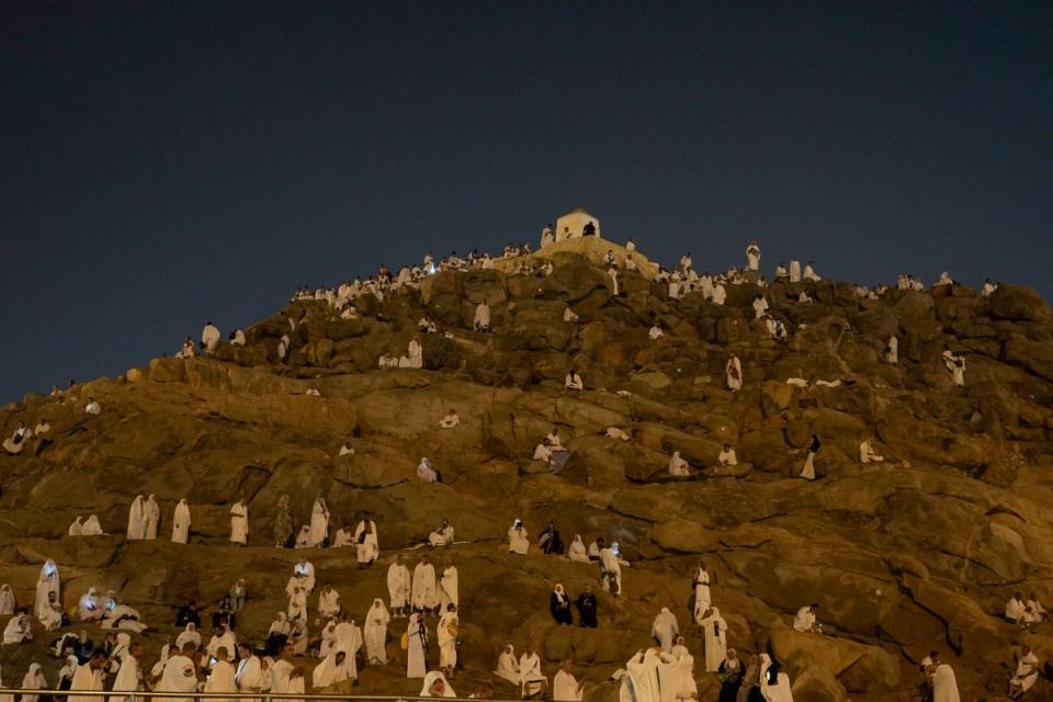 Muslim pilgrims gather at top of the rocky hill known as the Mountain of Mercy, on the Plain of Arafat, during the annual Hajj pilgrimage, near the holy city of Mecca, Saudi Arabia, Saturday, 15 June 2024 (Copyright 2024 The Associated Press. All rights reserved)