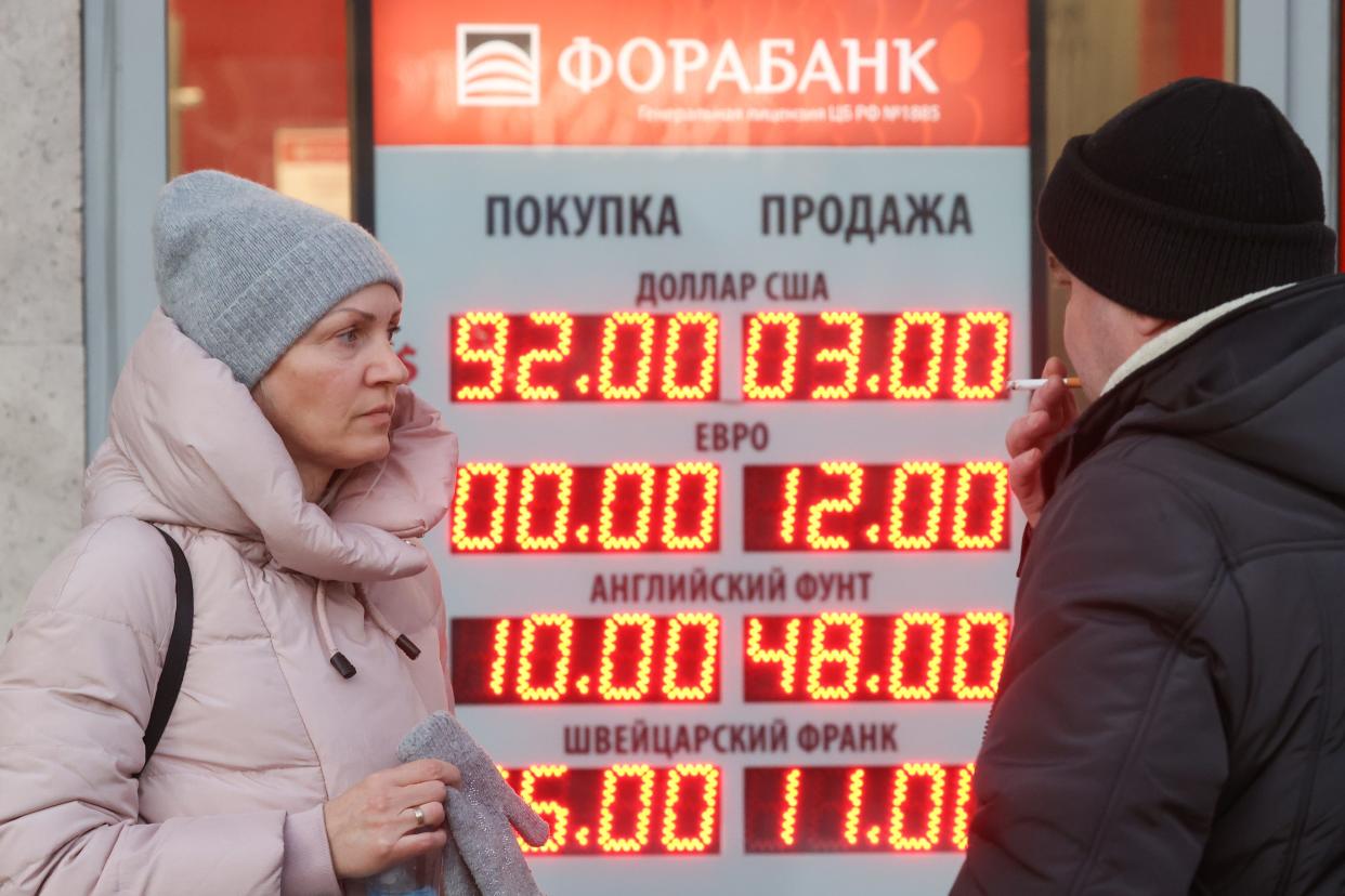 A digital board shows the exchange rate of the rouble against the US dollar and euro in Moscow, Russia.
