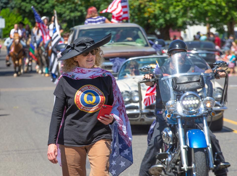 Organizer Julie Bivens participates in the unpermitted Fourth of July parade in Creswell, Oregon, wearing a QAnon T-shirt.