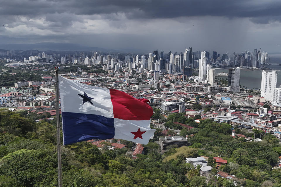 FILE - A Panamanian flag flies on Ancon hill backdropped by the skyline of Panama City, days ahead of the presidential election, May 2, 2024. On May 5th, Panamanians elected José Raúl Mulino who ran on the promise to usher in another wave of economic prosperity and to stop migration through the Darien Gap, the jungle region overlapping Colombia and Panama that was traversed by half a million migrants last year. (AP Photo/Matias Delacroix, File)