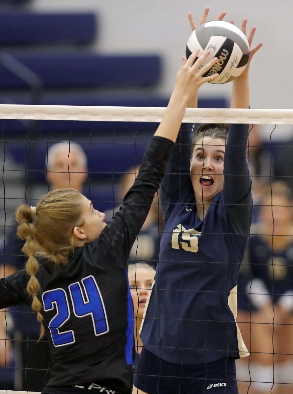 Hoban senior Molly Kennedy, facing, blocks CVCA senior Gabby Larison during the second set of a Division II district semifinal volleyball match, Wednesday, Oct. 26, 2022, in Tallmadge, Ohio.