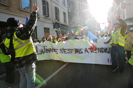 Protesters wearing yellow vests take part in a demonstration of the "yellow vests" movement in Marseille, France, January 5, 2019. The writing on the banner reads, "France is not for sale". REUTERS/Jean-Paul Pelissier