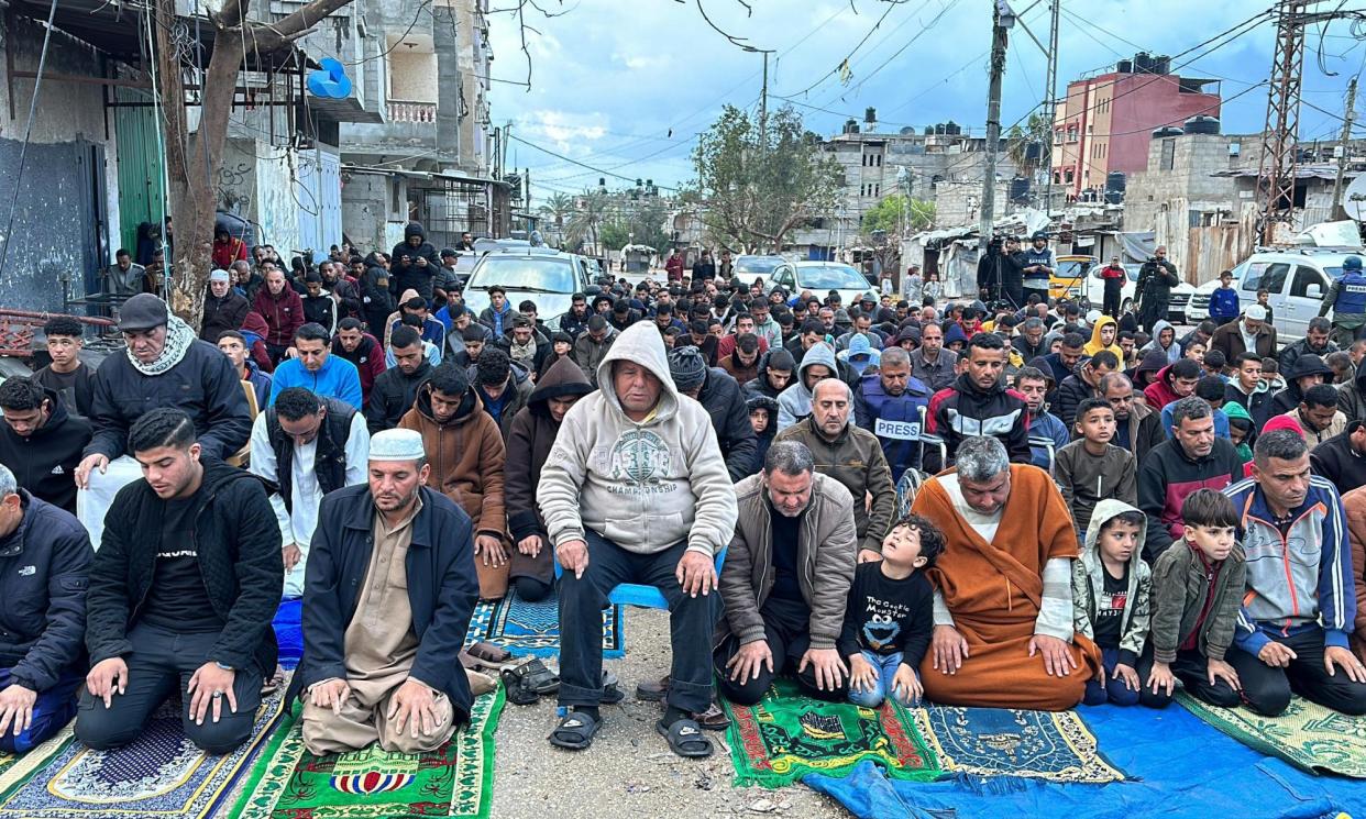 <span>Muslims perform Eid al-Fitr prayer in the street next to the rubble of Rafah’s al-Farouk mosque.</span><span>Photograph: Anadolu/Getty Images</span>