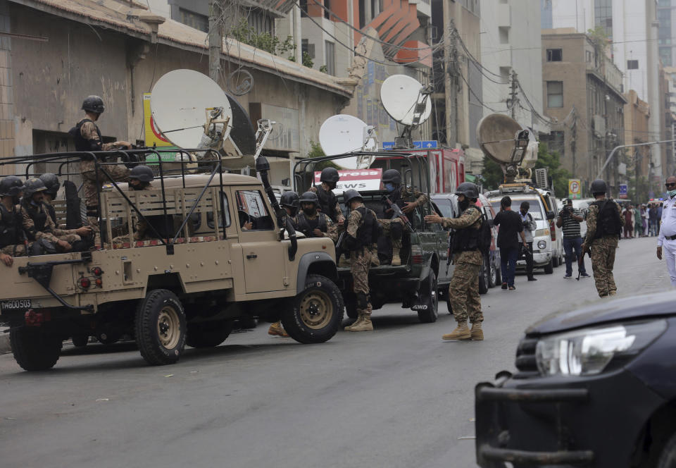 Security personnel surround the Stock Exchange Building in Karachi, Pakistan, Monday, June 29, 2020. Gunmen have attacked the stock exchange in the Pakistani city of Karachi on Monday. Special police forces deployed to the scene of the attack and in a swift operation secured the building. (AP Photo/Fareed Khan)